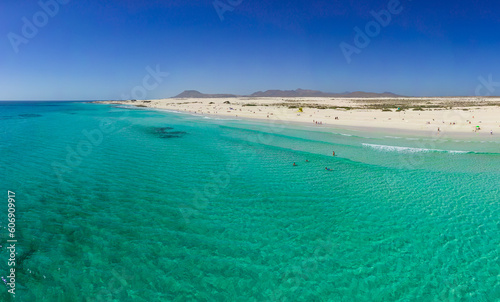 Fototapeta Naklejka Na Ścianę i Meble -  Beautiful mid level aspect aerial panoramic view of Grandes Playa beach with clear turquoise water near Corralejo in Fuerteventura Spain