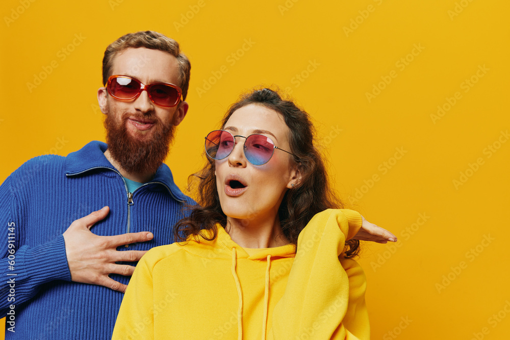 Man and woman couple smiling cheerfully and crooked with glasses, on yellow background, symbols signs and hand gestures, family shoot, newlyweds. Man and woman couple smiling cheerfully and crooked with glasses, on yellow background, symbols signs and hand gestures, family shoot, newlyweds.