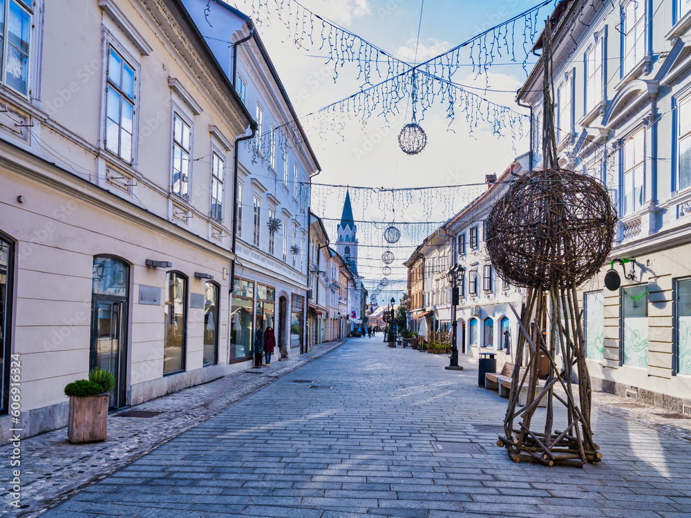 Kranj village tiled street decorated with Christmas lights at sunset, Kranj, Slovenia