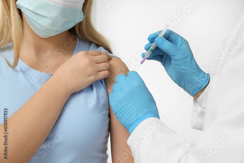 Doctor giving hepatitis vaccine to patient on white background  closeup