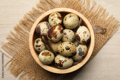 Speckled quail eggs on white table, top view