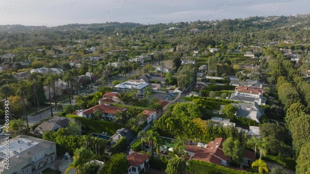 Fly above rich residencies in Beverly Hills at golden hour. Streets lined with rows of trees. Fly above rich residencies in Beverly Hills at golden hour. Streets lined with rows of trees.