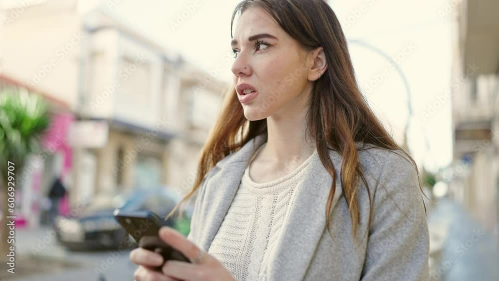 Young hispanic woman using smartphone looking upset at street Young hispanic woman using smartphone looking upset at street