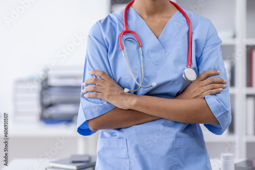 Happy doctor Portrait of young African American woman nurse smilingusing a laptop writing content at consultation photo