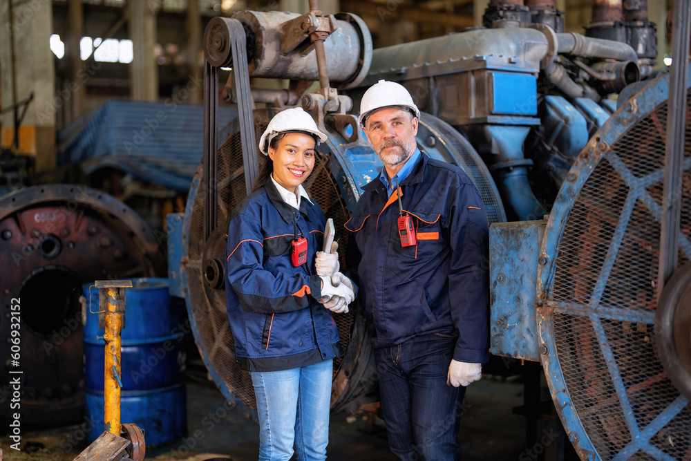 Workers and supervisor congratulations and hand check in heavy engine machine smile portrait

