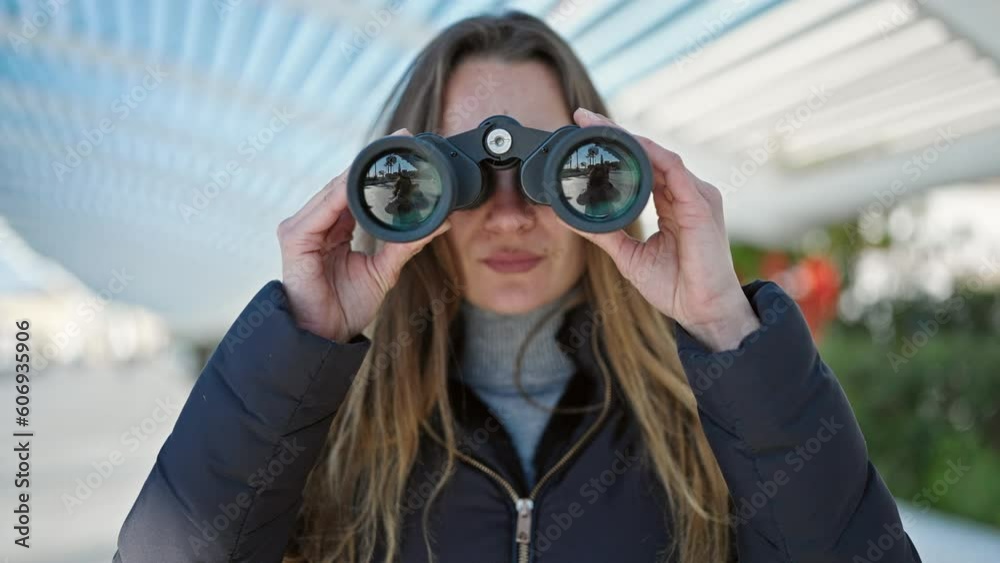 Young caucasian woman using binoculars at park Young caucasian woman using binoculars at park