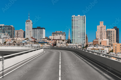 Empty urban asphalt road exterior with city buildings background. New modern highway concrete construction. Concept way to success. Transportation logistic industry fast delivery. San Francisco. USA.