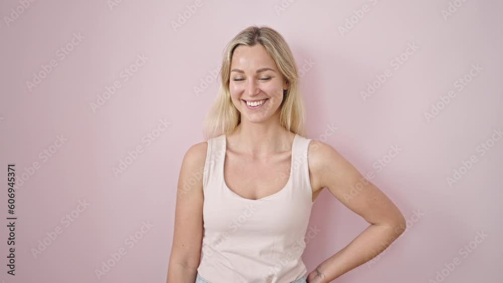 Young blonde woman smiling confident standing over isolated pink background Young blonde woman smiling confident standing over isolated pink background
