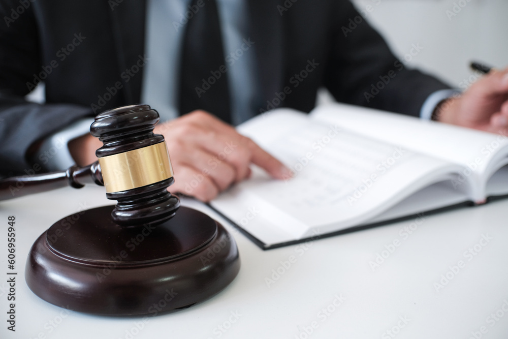 Legal counsel presents to the client a signed contract with gavel and legal law. justice and lawyer concept. Legal counsel presents to the client a signed contract with gavel and legal law. justice and lawyer concept.