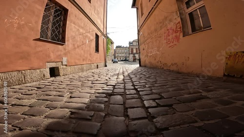 Low angle shot of a narrow and old alley in the Jewish quarter of Kazimierz in Krakow - Poland photo