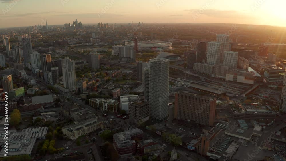 Circling aerial shot over Stratford at sunset with London skyline in the background Circling aerial shot over Stratford at sunset with London skyline in the background