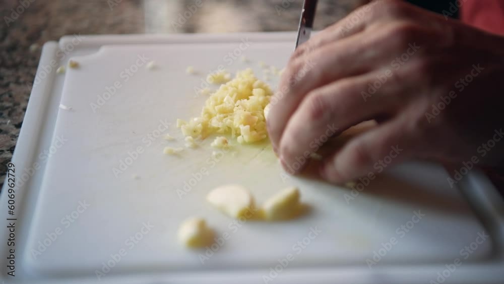 Knife Chopping Or Cutting Garlic On Kitchen Board Knife Chopping Or Cutting Garlic On Kitchen Board