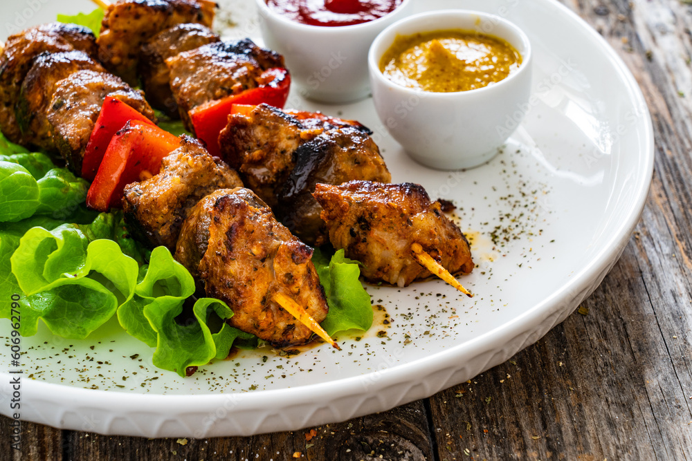 Meat skewers - grilled meat with vegetables on wooden background
Meat skewers - grilled meat with vegetables on wooden background