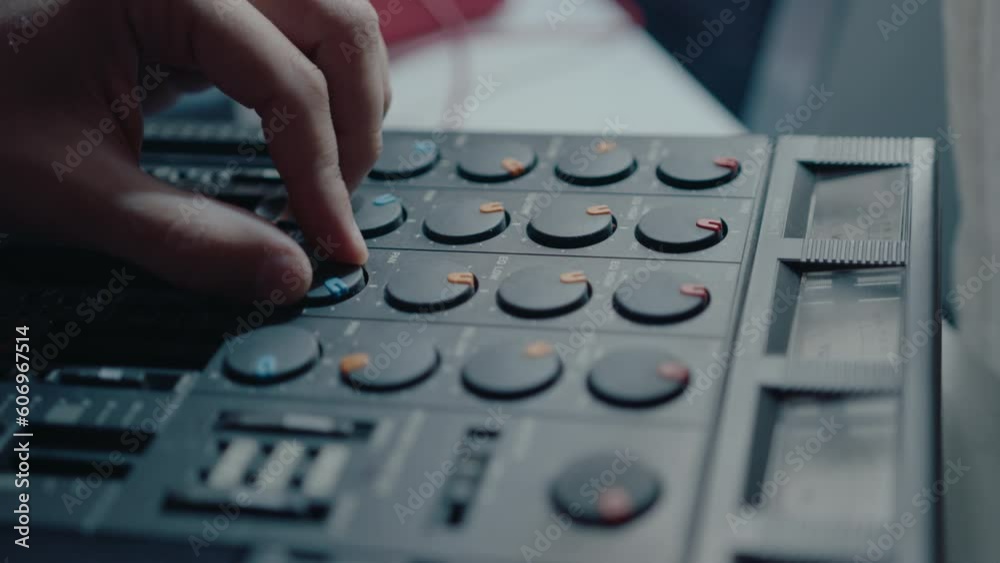 Close-up shot of hand of musician using slider and knobs on vintage multitrack cassette recorder when creating his own music Close-up shot of hand of musician using slider and knobs on vintage multitrack cassette recorder when creating his own music