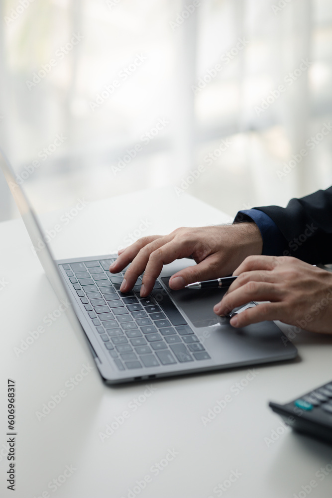 Person typing on laptop keyboard, businessman working on laptop, he is typing messages to colleagues and making financial information sheet to sum up the meeting. Person typing on laptop keyboard, businessman working on laptop, he is typing messages to colleagues and making financial information sheet to sum up the meeting.