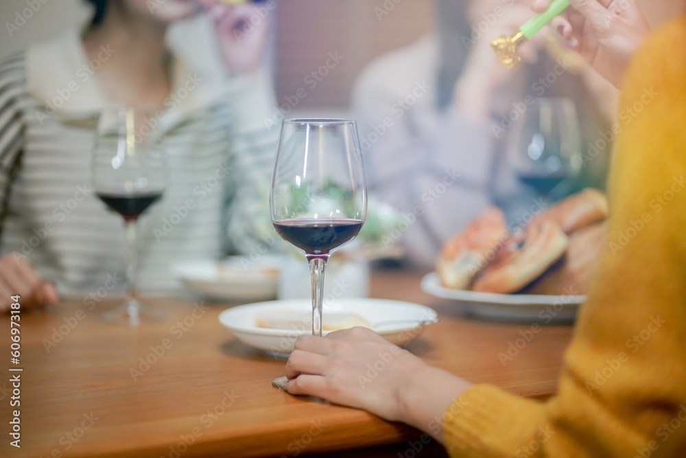 Cheerful friends enjoying home Birthday holiday party. Asian Friends cheering drinking red wine celebrating New Year party. Cheerful friends enjoying home Birthday holiday party. Asian Friends cheering drinking red wine celebrating New Year party.