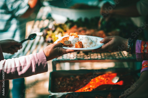 Feeding concept: Homeless people offer free food from outdoor volunteers.