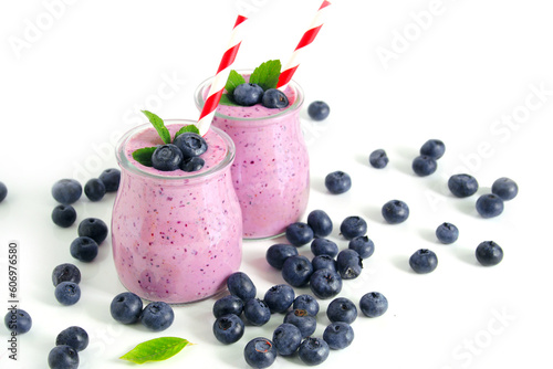 Two glasses of blueberry smoothie on white background. Selective focus
