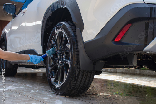 Car wash, hand cleaning car wheel