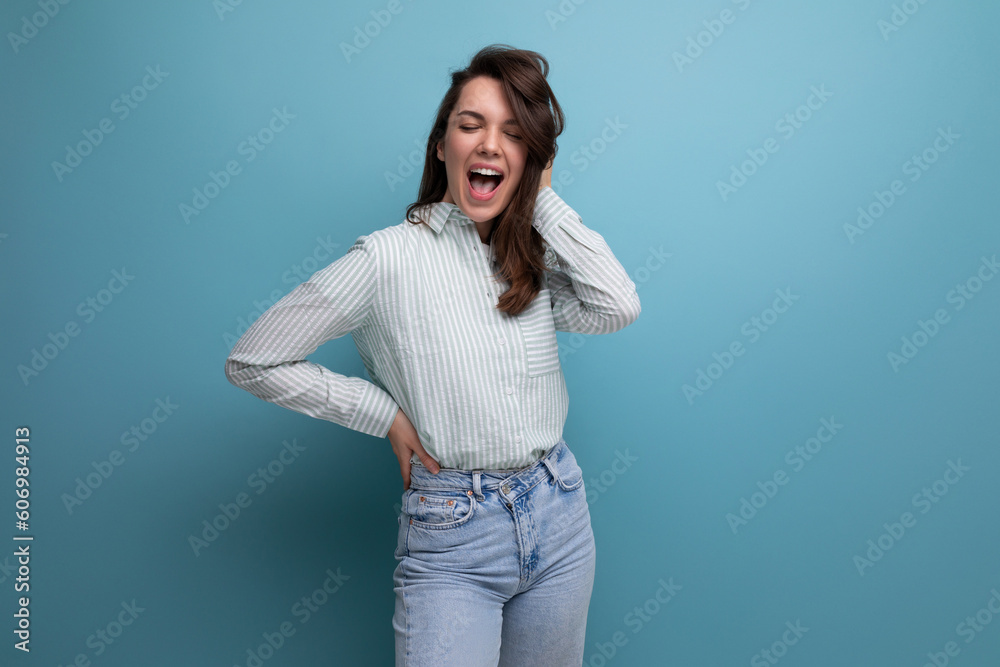 funny young brunette lady dressed in a striped shirt and jeans on a studio background funny young brunette lady dressed in a striped shirt and jeans on a studio background