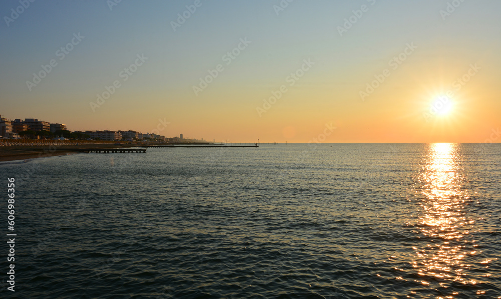 the sun on the horizon rises early in the morning on the beaches of the Adriatic Sea