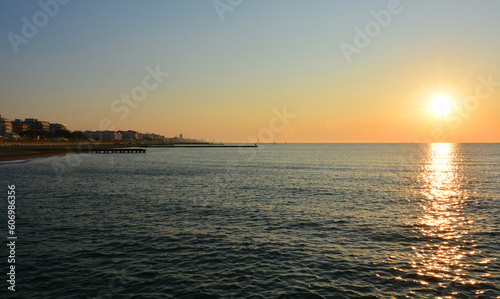 the sun on the horizon rises early in the morning on the beaches of the Adriatic Sea