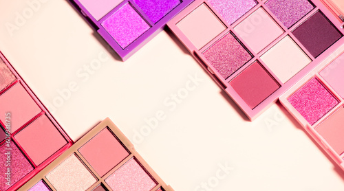 Makeup palette set isolated on beige background. Professional multicolor eyeshadow palette. Makeup. Professional multicolor eye shadow make-up palette  close-up. Various Colorful bright eye shadows