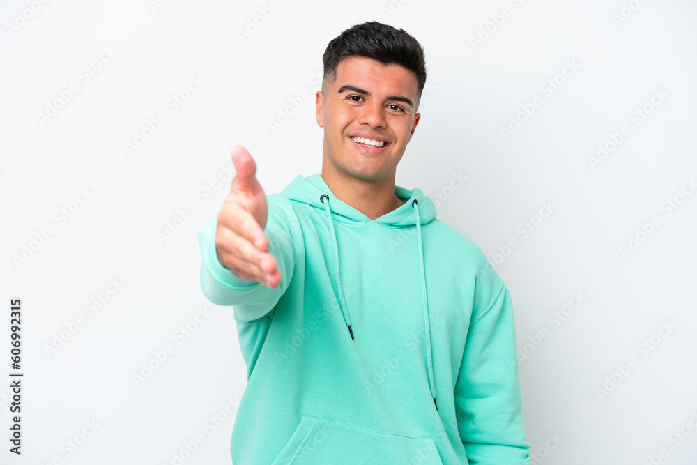 Young caucasian handsome man isolated on white background shaking hands for closing a good deal Young caucasian handsome man isolated on white background shaking hands for closing a good deal