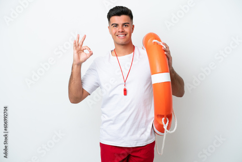 Young handsome man isolated on white background with lifeguard equipment and showing ok sign with fingers