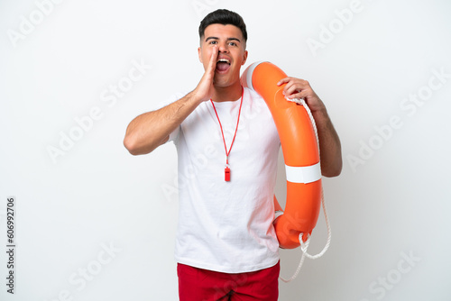 Young handsome man isolated on white background with lifeguard equipment and shouting with mouth wide open