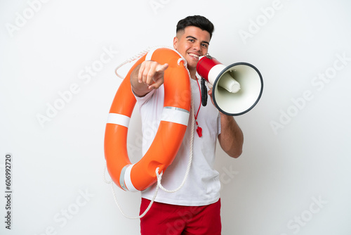 Young handsome man isolated on white background with lifeguard equipment and shouting through a megaphone