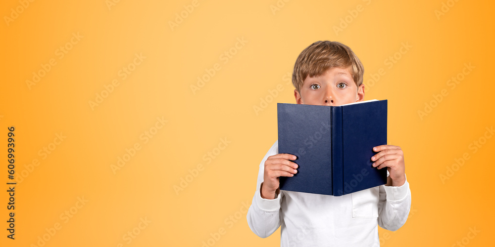 Surprised schoolboy with book, orange Surprised schoolboy with book, orange