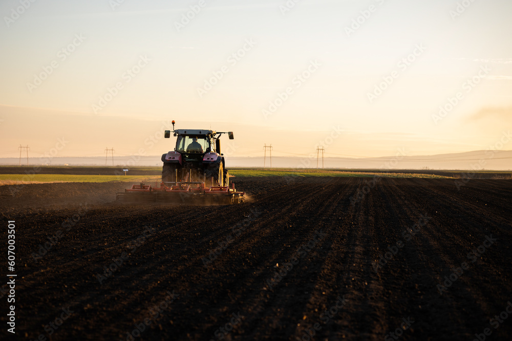 Farmer preparing his field in a tractor Farmer preparing his field in a tractor