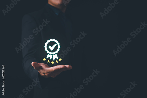 Businessman holding and showing the best quality assurance. Quality control certification and standardization. ISO service concept.