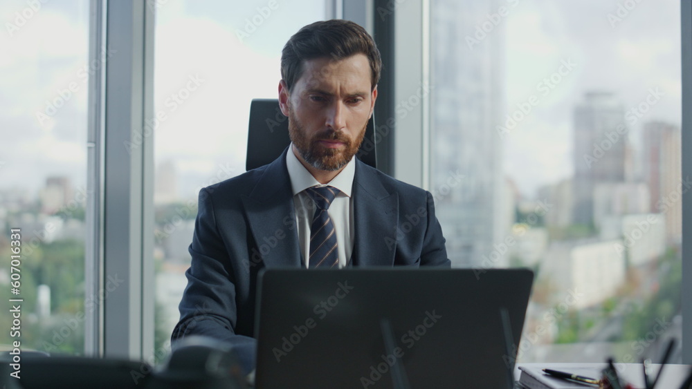 Portrait focused businessman working at office using laptop. Ceo manager typing. Portrait focused businessman working at office using laptop. Ceo manager typing.