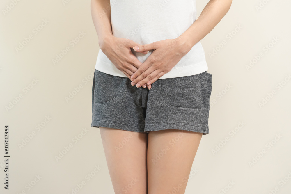 Vaginal, urinary incontinence. Pain asian young woman hand holding