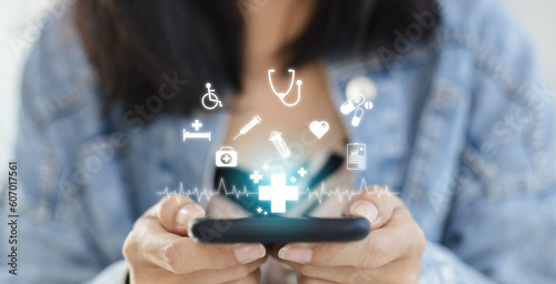 Technology network healthcare concept. Female using smartphone with virtual medical healthcare. Network connection online communication to hospital.