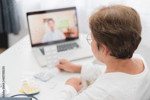 Taking medication on doctor's advice through laptop At home, telemedicine concept.