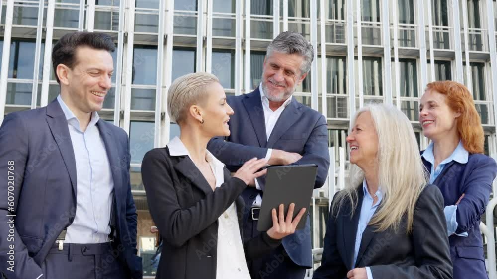 Stylish businesswoman using a tablet to explain something to colleagues Stylish businesswoman using a tablet to explain something to colleagues