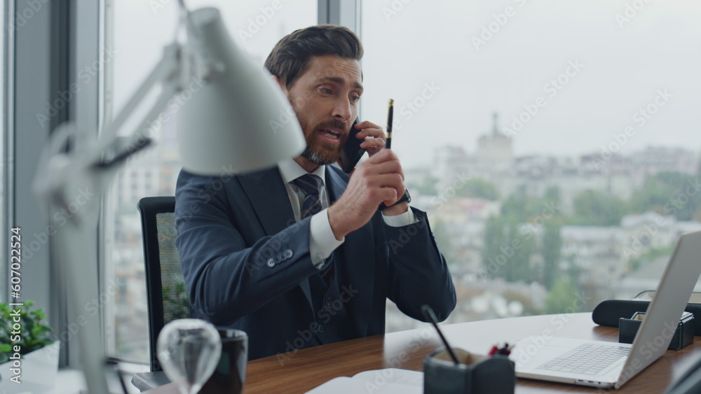 Annoyed director arguing phone call sitting at office desk closeup. Man shouting Annoyed director arguing phone call sitting at office desk closeup. Man shouting