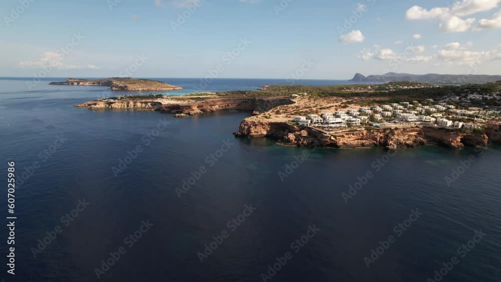 Aerial view of sapphire-blue waters surrounded by mountainous land on the island of Ibiza Aerial view of sapphire-blue waters surrounded by mountainous land on the island of Ibiza