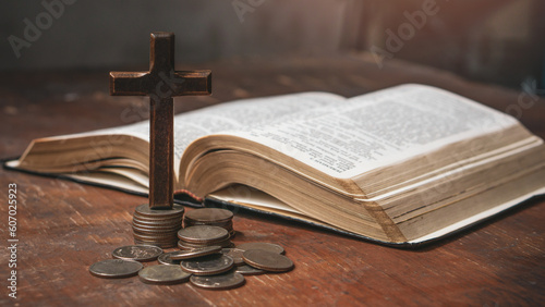 Tithe concept. Cross and coins with Holy Bible. Biblical concept of Christian offering, generosity, and giving tithes in church. photo