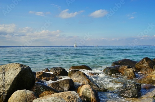 Fototapeta Naklejka Na Ścianę i Meble -  Sailboat in Baltic Sea at a distance seen from the rocks by Travemuende beach