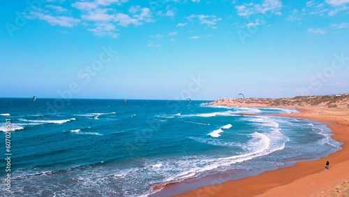 Canvas Print A group of people kite surfing at Alagadi Beach in Kyrenia, North Cyprus on sunn