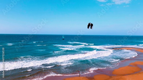 Photography A group of people kite surfing at Alagadi Beach in Kyrenia, North Cyprus on sunn