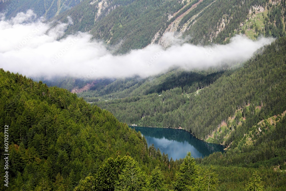 Bird's-eye view of a lake surrounded by forest mountains