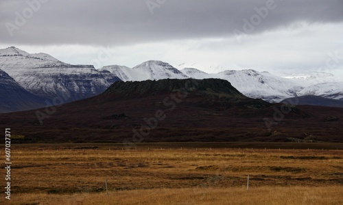 View of Eldborg mountain with the snowy range in the background. Snaefellsnes, Iceland. photo