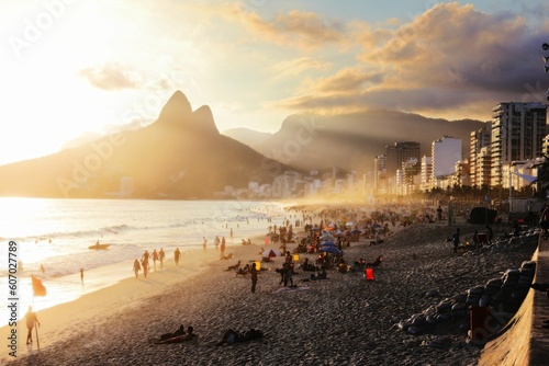 Crowd of people enjoying the majestic sunset at Ipanema beach in Rio de Janeiro, Brazil photo