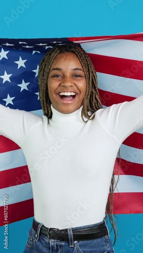 Proud african woman raising a north american flag