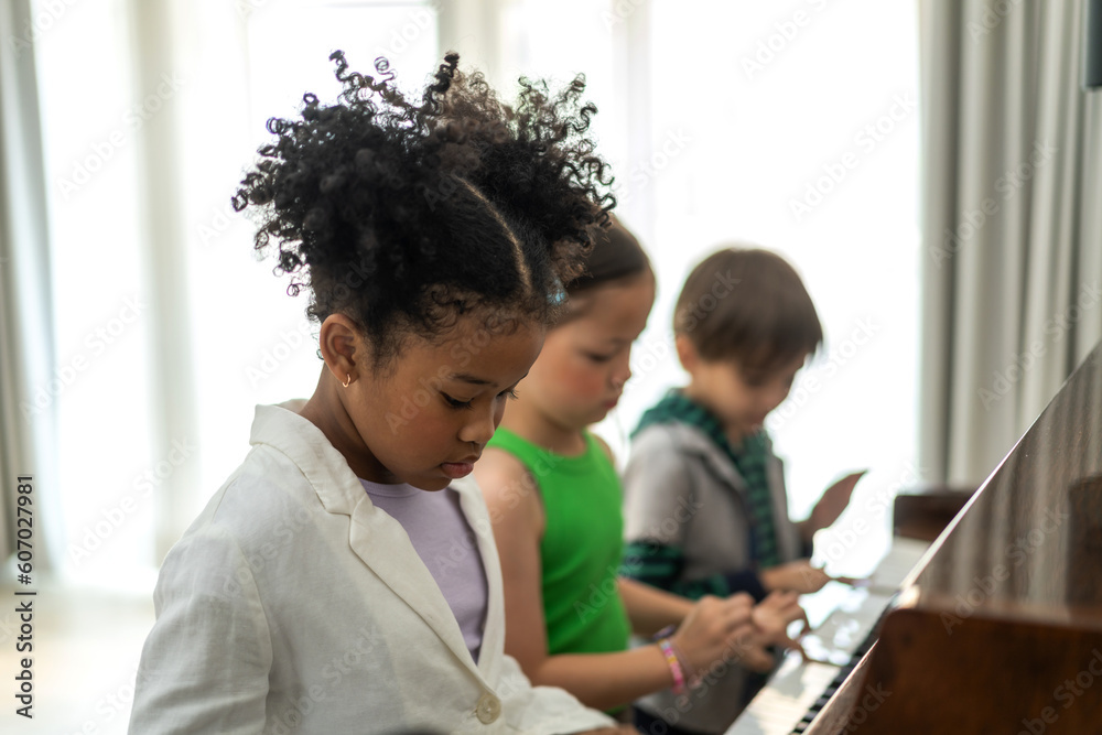 Young student musician girl kid having fun activities learn, study, play piano music lesson in music education at school Young student musician girl kid having fun activities learn, study, play piano music lesson in music education at school